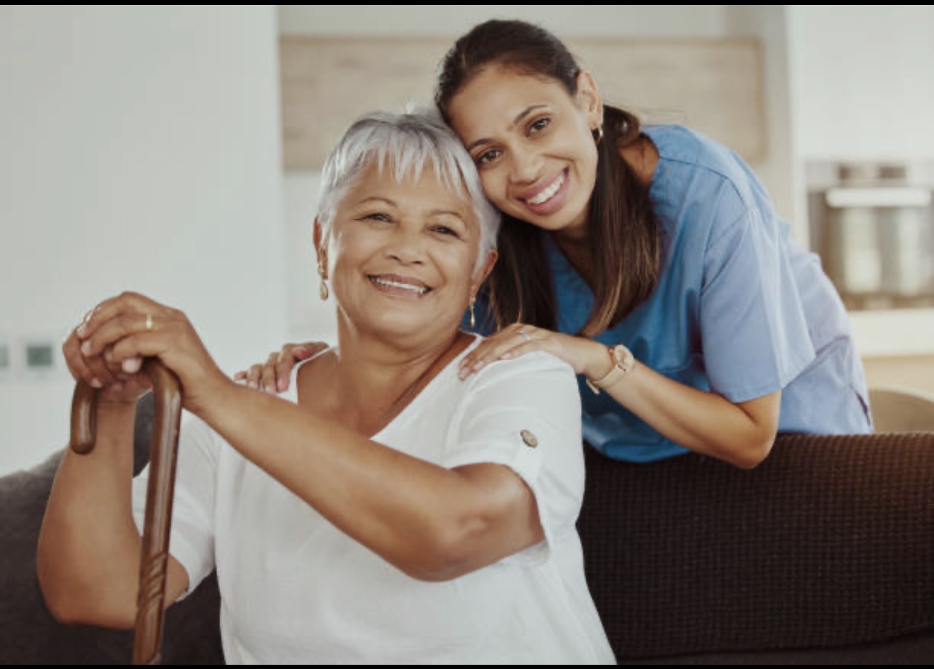 Caregiver and senior sharing a warm moment at home